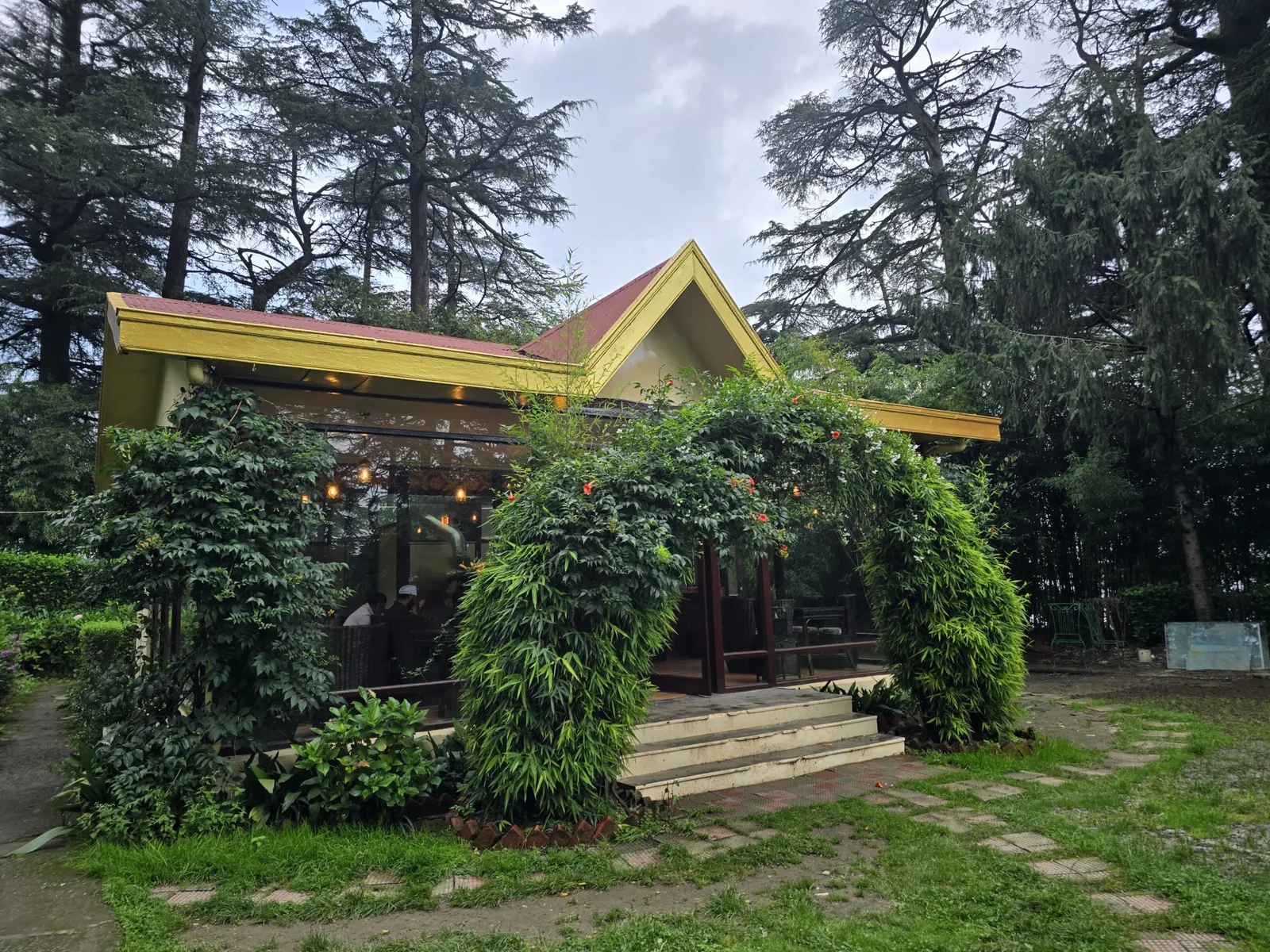 Heritage Cafe 1938 exterior with flowering creeper over the glass frontage