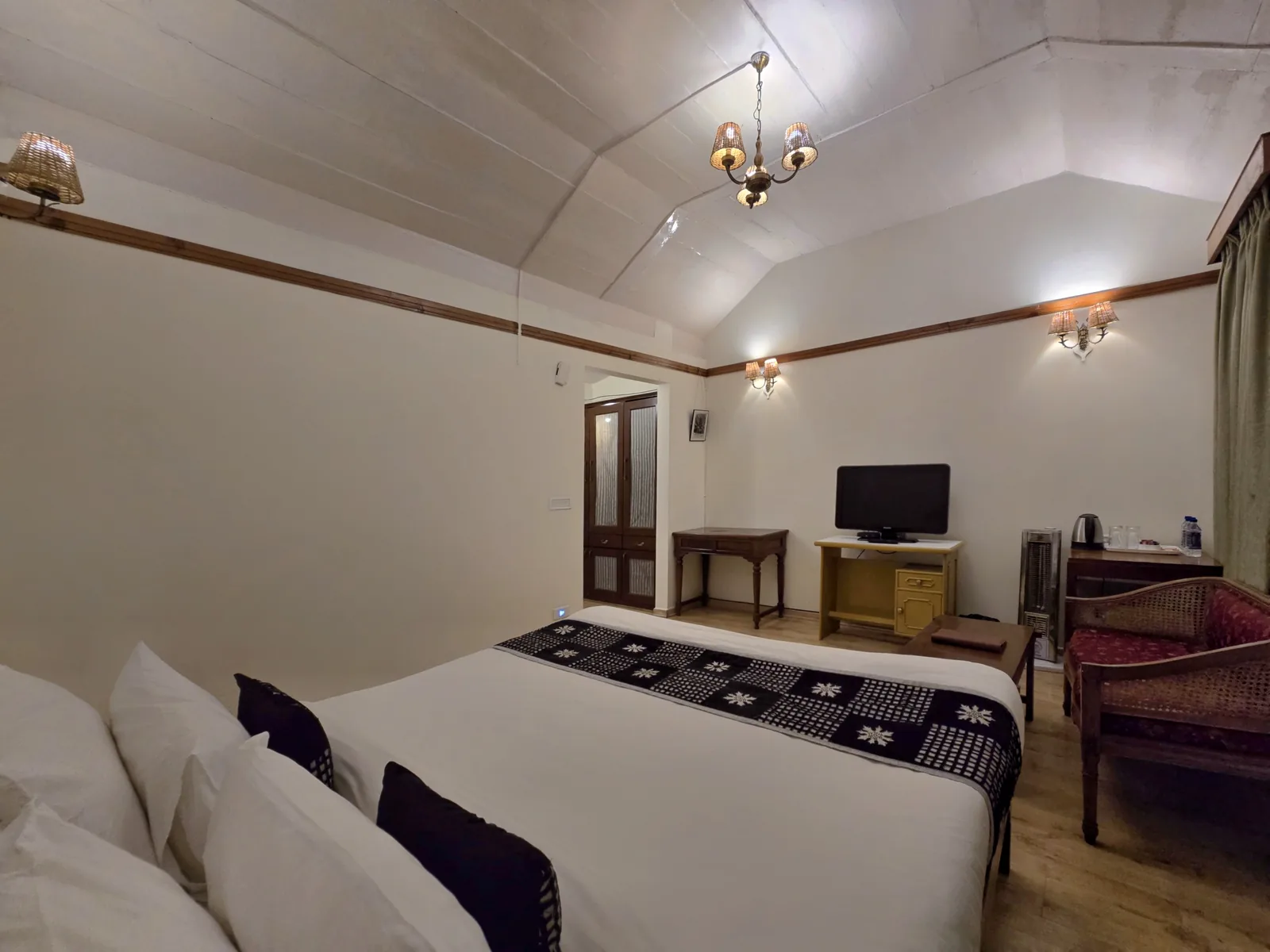 Heritage Classic room from the foot of the bed, with a writing desk and television