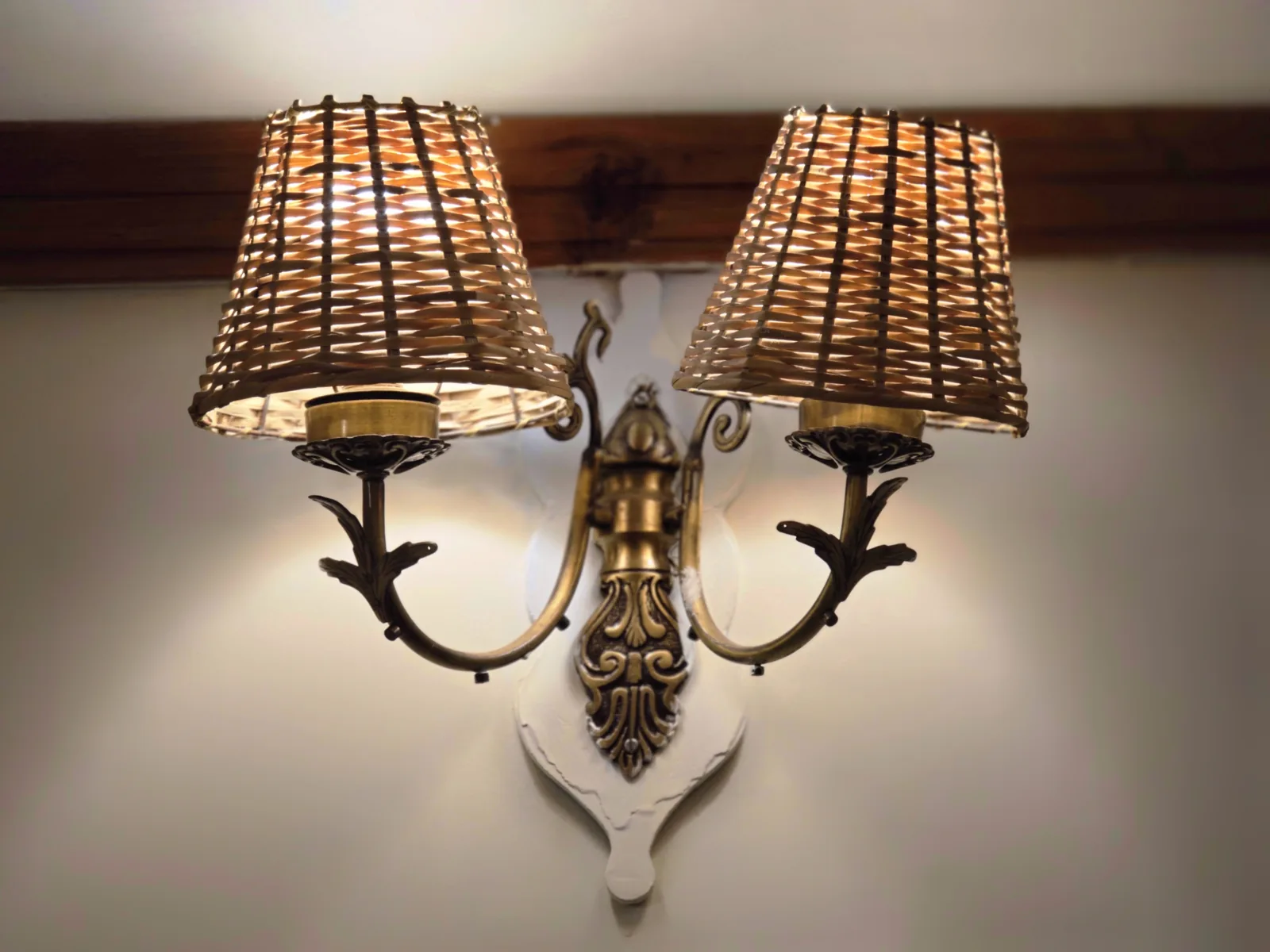 Wicker-shaded brass wall lamp, a detail from the Heritage Classic rooms