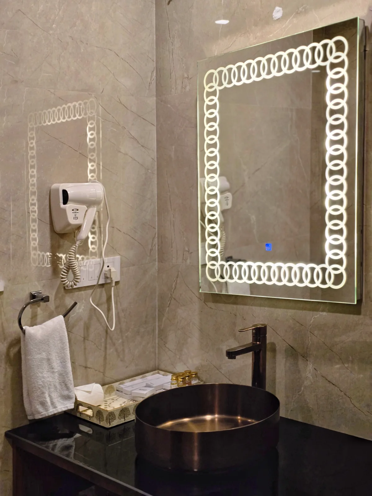 Backlit mirror and copper basin in the Himalayan Suite bathroom