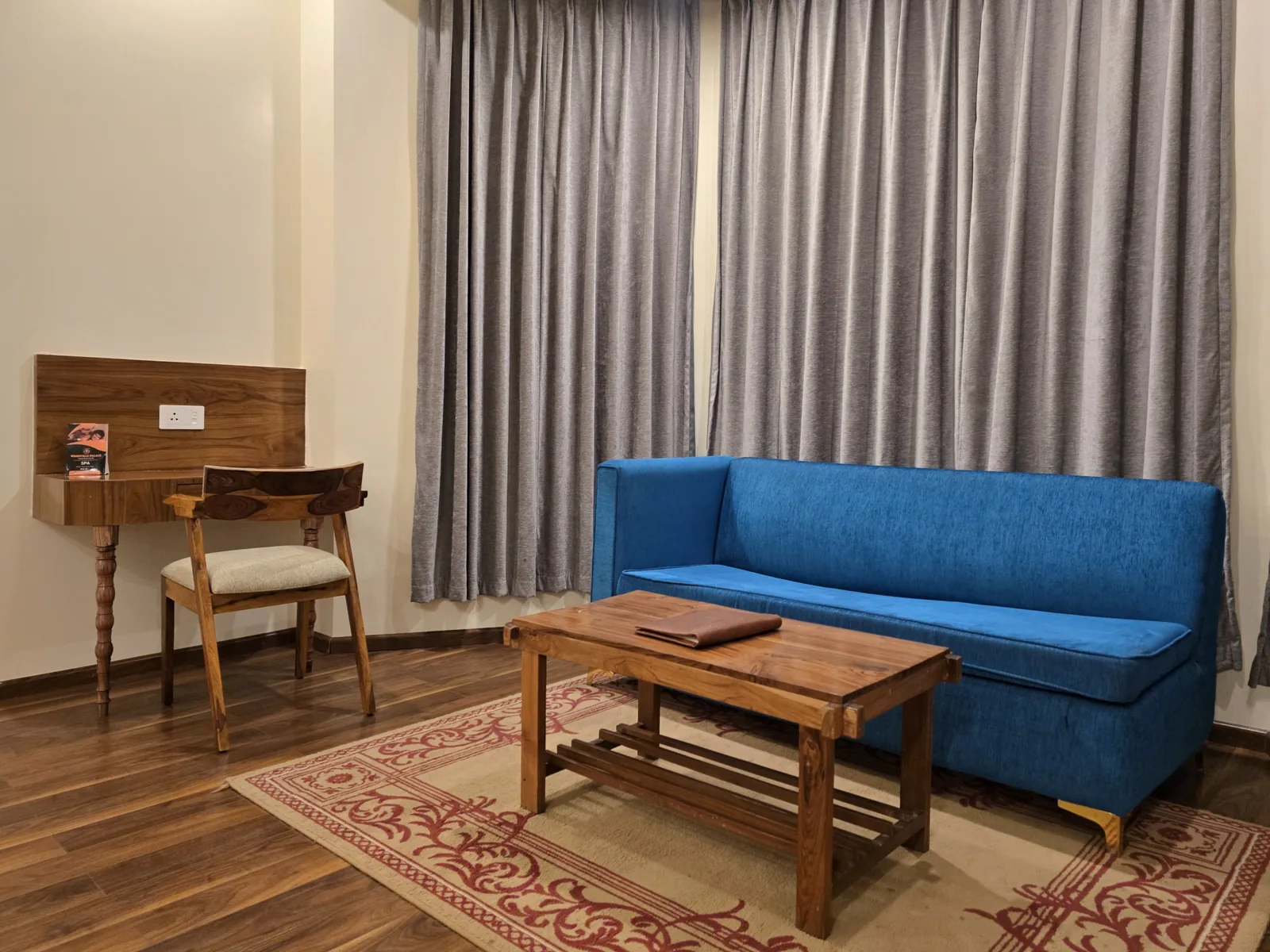 Imperial Room seating area with a blue sofa, writing desk and low table