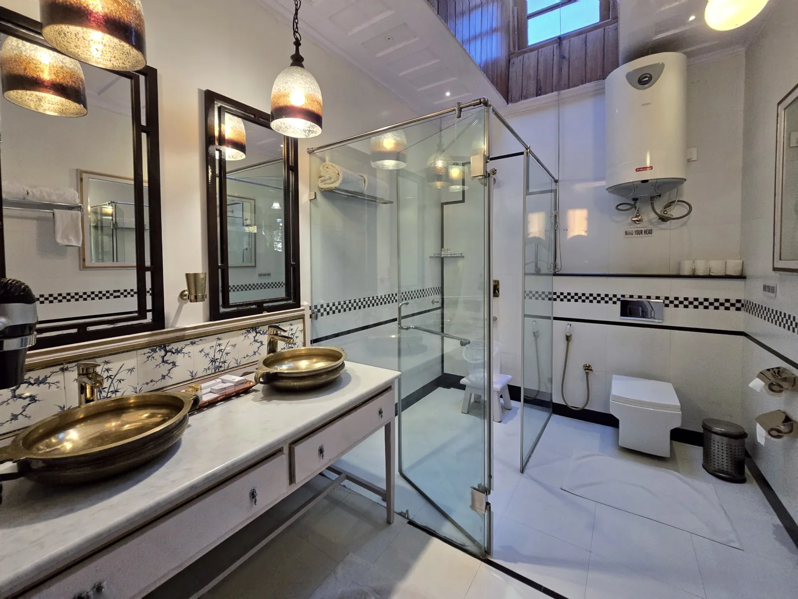 Heritage Bollywood Suite bathroom with a glass shower and brass basins