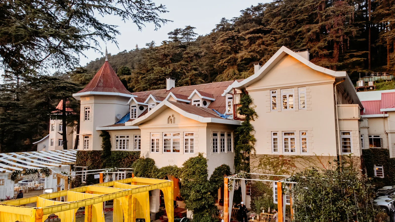 Woodville Palace Shimla dressed for a wedding — yellow marigold mandap and drapes on the lawn below the heritage facade