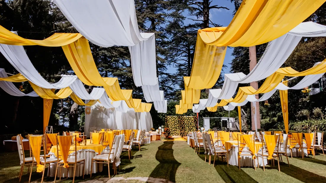 Aerial view of Woodville Palace Shimla during a haldi ceremony — marigold-yellow drapes across the lawn