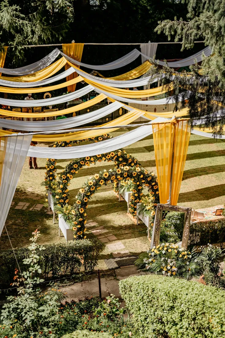 Haldi ceremony decor at Woodville Palace Shimla — sunflowers, marigold and yellow drapes on the palace lawn