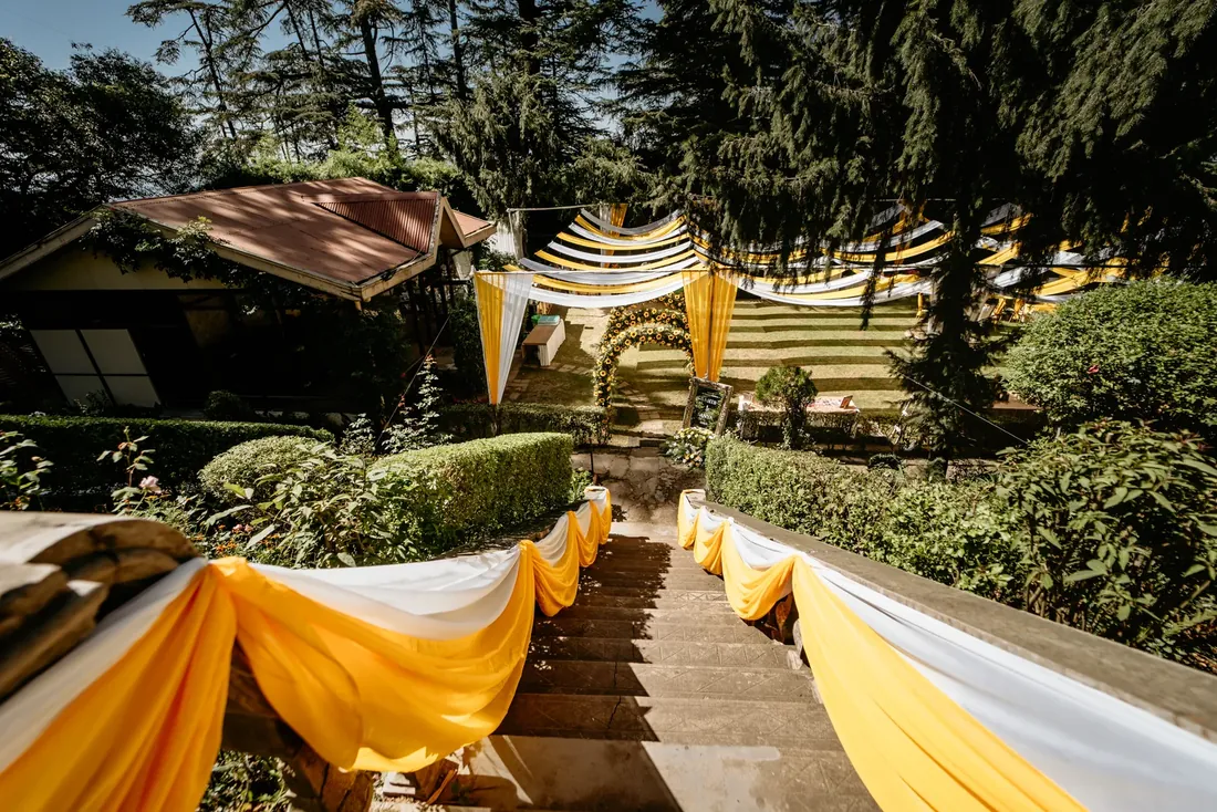 Haldi ceremony decor at Woodville Palace Shimla — sunflowers, marigold and yellow drapes on the palace lawn